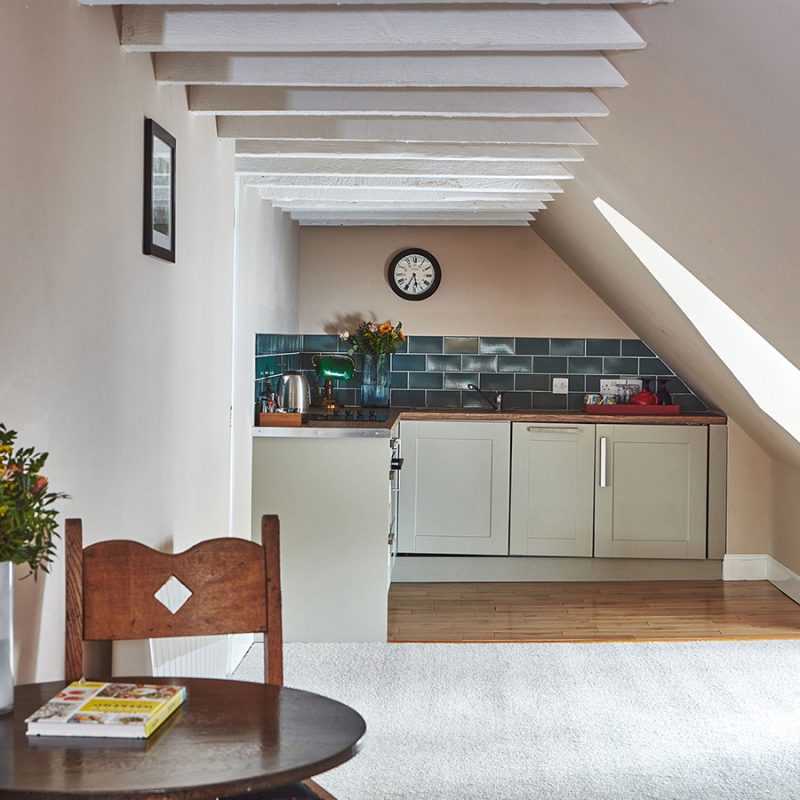 The open plan kitchen and dining in the eaves in the Attic Apartment part of Brambles of Inveraray Hotel in Scotland