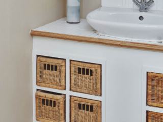 The sink and wicker drawers in the bathroom in the Garden Suite in Brambles hotel in Inveraray in Scotland