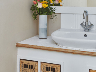 The sink and wicker drawers in the bathroom in the Garden Suite in Brambles hotel in Inveraray in Scotland