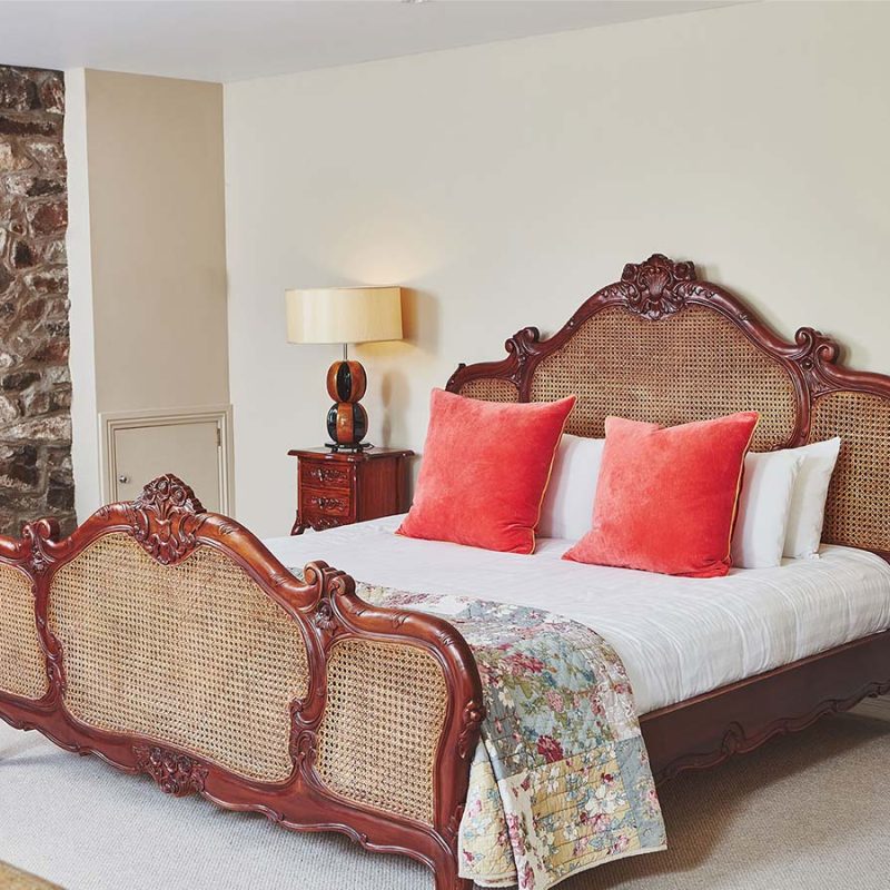 An ornate rattan double bed in the Garden Suite in Brambles of Inveraray Hotel in Scotland