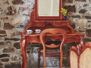 An ornate antique dressing table in the double bedroom in the Garden Suite in Brambles hotel in Inveraray in Scotland